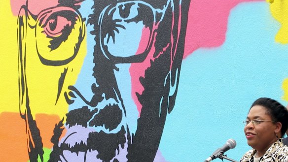 Jennifer Pinckney speaks beside an image of her late husband, the Reverend Clementa Pinckney, one of the victims of the shooting at Charleston's Emanuel AME Church.