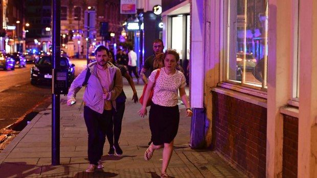 People run down Borough High Street as police deal with a "major incident" at London Bridge.
