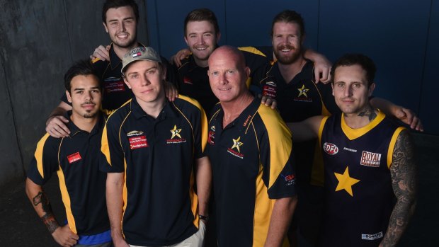 Essendon VFL footballer Charles Lill with Doutta Stars coach Dean Wallis and his teammates at Windy Hill.