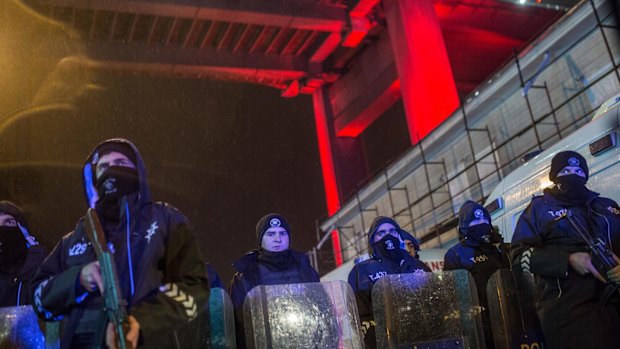 Turkish police secure the area at Ortakoy district under Bosphorus Bridge near night club Reina.