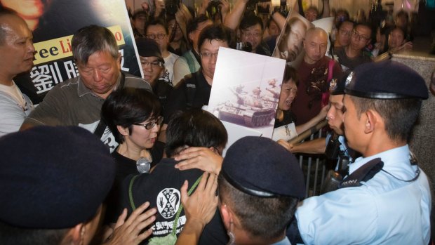 Pro-democracy activists clash with police at a security barricade in Hong Kong on Friday.