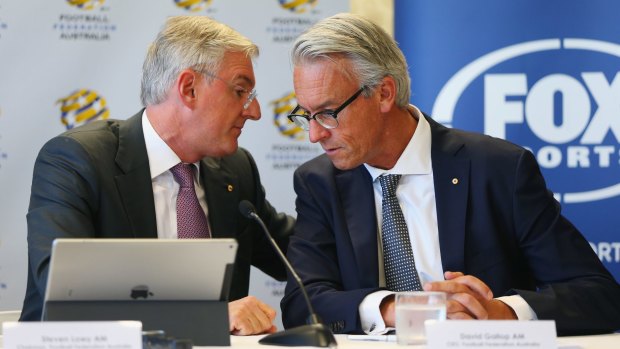 Table talk: FFA chairman Steven Lowy and CEO David Gallop confer at a press conference where they annnounced a six year deal pay-TV deal.