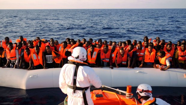 Migrants on a rubber dinghy are rescued by the vessel Responder, run by the Malta-based NGO Migrant Offshore Aid Station (MOAS) and the Italian Red Cross