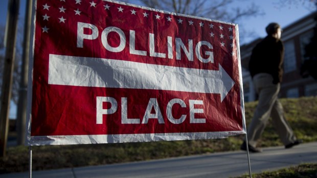 A "Polling Place" sign stands outside the Madison Activities Centre polling location in Arlington, Virginia.
