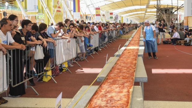 The world's longest pizza shortly before it was devoured in Milan on Saturday.