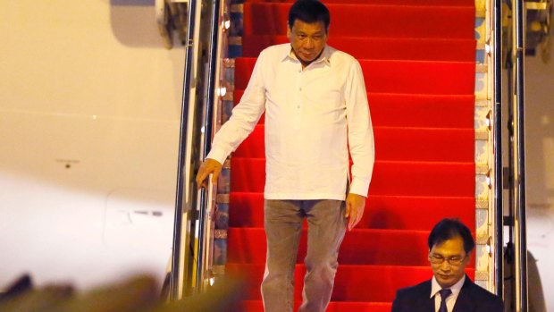 Philippine President Rodrigo Duterte steps down the plane as he embarks on his first foreign trip to Vientiane, Laos.