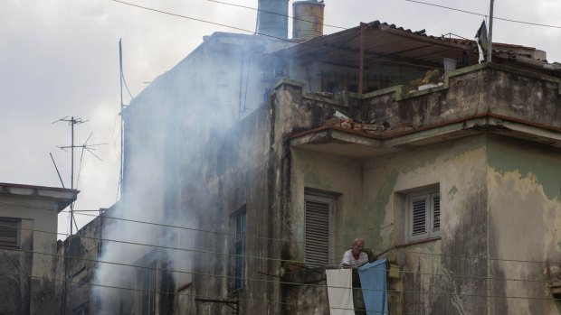 Soldiers fumigate a home in Havana, Cuba, on Monday to kill mosquitoes that carry the Zika virus. 