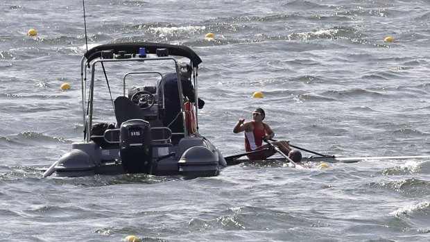 A training rower from Peru receives assistance due to the high winds.