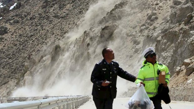 People in Nyalam county in the Tibet Autonomous Region run from a landslide triggered by a tremor following the 7.9-magnitude earthquake that hit the region on Saturday.