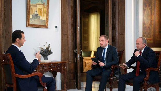 Syrian President Bashar Assad, left, during an interview with Russian TV channels Russia 24 and NTV in Damascus on Wednesday. Assad said the liberation of Aleppo will not end with taking the city, which should be secured from the outside.