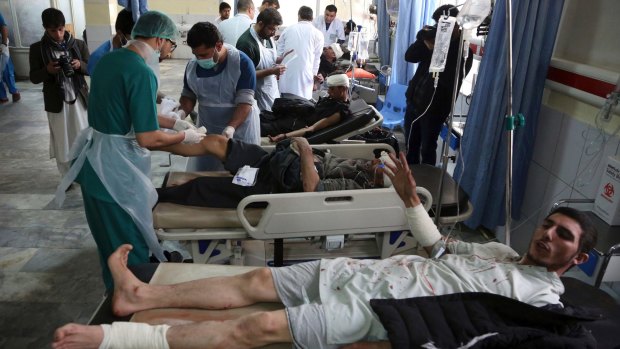 Injured men receive treatment after the attack in Kabul.