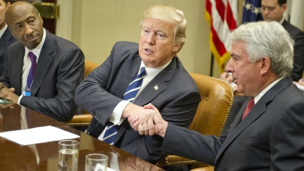 US President Donald Trump shakes hands with Robert Hugin, chairman of Celgene Corporation, alongside Merck CEO Ken Frazier (left) during a meeting with pharmaceutical company representatives at the White House in January.