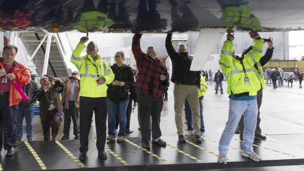 Touching history: Passengers sign a Delta Boeing 747-400 on Monday after a flight to Paine Field in Everett, Washington.
