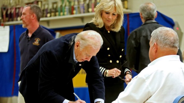 Vice-President Joe Biden and his wife, wife Jill Biden, sign the voters' register Tuesday morning.