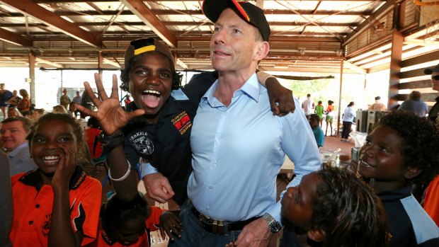 Prime Minister Tony Abbott with excited school children at Yirrkala School during his visit to North East Arnhem Land in September last year.