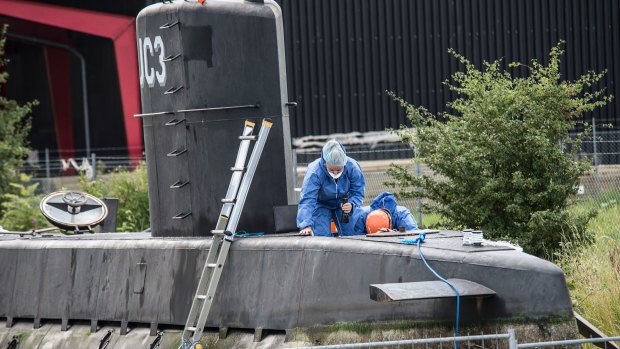 Police technicians scan the submarine where Swedish journalist Kim Wall was allegedly killed.