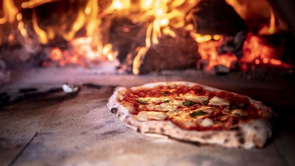 Feeling hot, hot hot: Grossi's simple margherita pizza being cooked in a wood-fired oven.