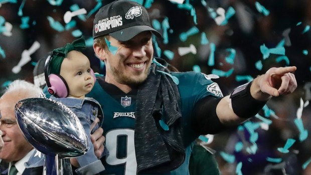 Philadelphia Eagles' Nick Foles holds his daughter Lily after beating the New England Patriots in the Super Bowl.