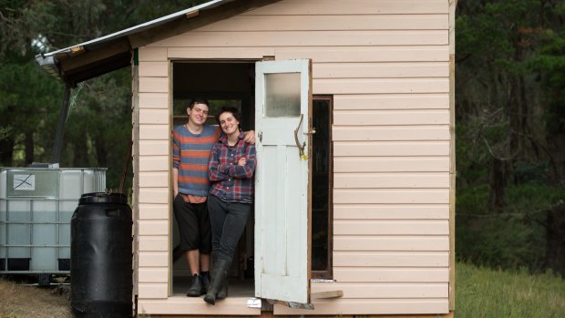 Rachel Newby and Liam Culbertsonin the doorway of their shack.