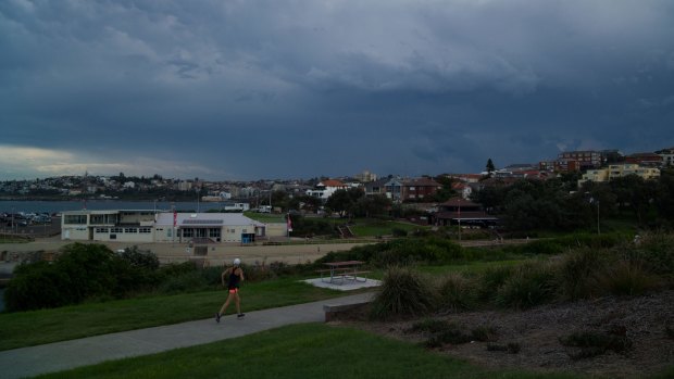 A jogger at Clovelly just before the storm front hit the coast on Wednesday.