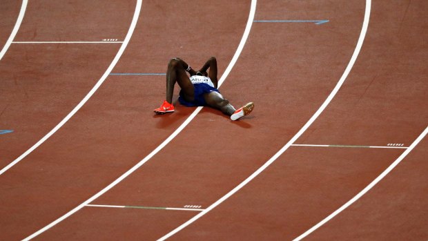 Britain's Mo Farah lies on the track after taking silver 
