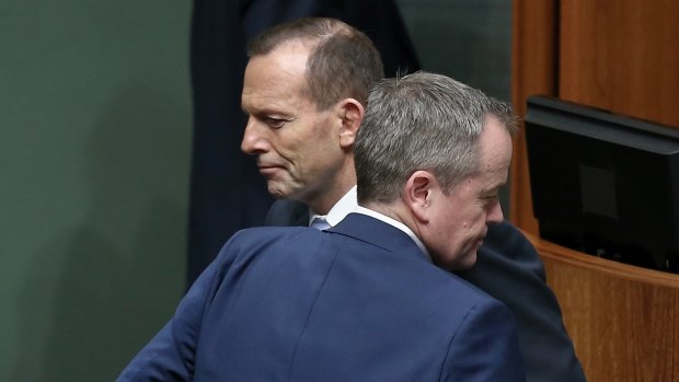 Prime Minister Tony Abbott and Opposition Leader Bill Shorten cross paths during a division in the House of Representatives.