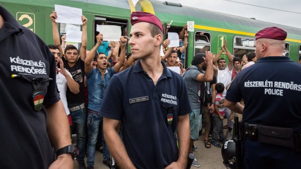 Refugees protest against being taken to a camp from a train at Bicske station on Thursday.