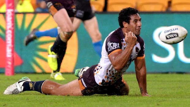 Land slide: Tautau Moga of the Broncos celebrates one of his side's many tries of the evening.