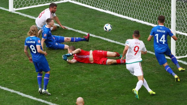 Oh no: Birkir Saevarsson scores an own goal after pressure from Daniel Bode to make the score 1-1 during the EURO 2016 Group F match between Iceland and Hungary at Stade Velodrome.