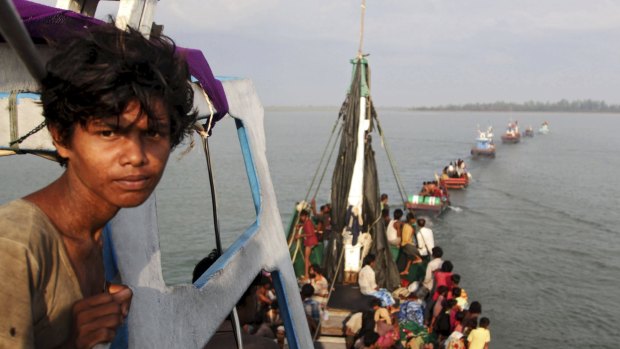 A fishing boat carrying Rohingya and Bangladeshi migrants is pulled to shore by Achenese fisherman in May.