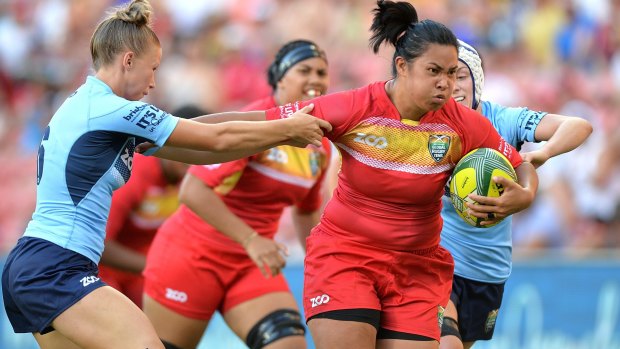 True grit: Liz Patu of Queensland takes on the NSW defence.