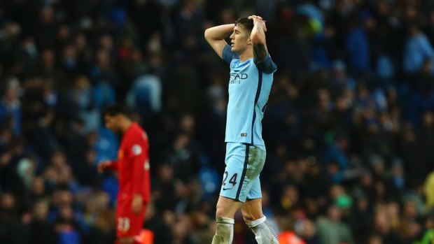 Opportunity spurned: Manchester City's John Stones leaves the field after taking just a point against Liverpool at home.