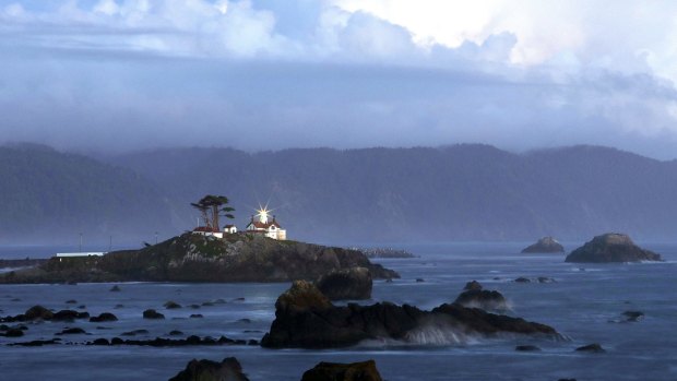 The beacon at Battery Point Lighthouse in Crescent City shines at sunset..
