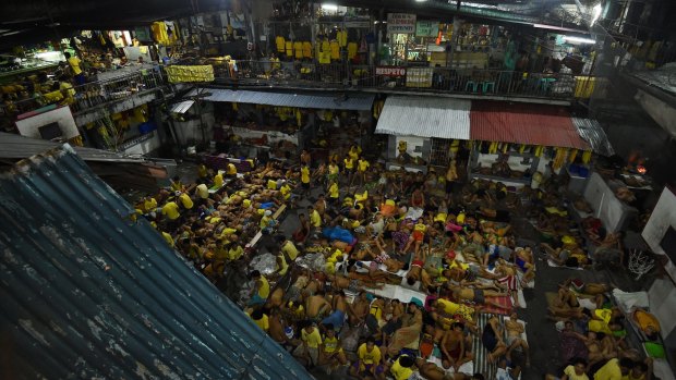 Some of the 3562 inmates sleep on any available space on the basketball court in jail in Manila, Philippines. The congestion is due to the war on drugs.