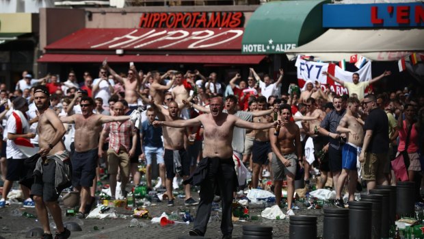 England fans gather, cheer and clash with police ahead of the game against Russia.