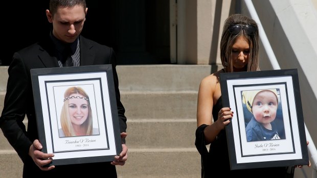 Relatives of the Rozelle blast victims Bianka and Jude O'Brien carry their photographs during their funeral service at St Joseph's Catholic Church.