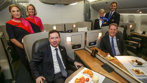 Alan Joyce, left, and Doug Parker in the first-class cabin of one of the US airline's Boeing 777 aircraft that will fly daily into Sydney from December 19. 