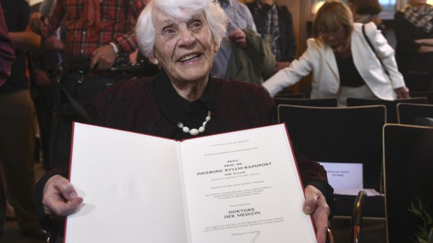 Retired German neonatologist Ingeborg Syllm-Rapoport,102, poses with her doctoral certificate.