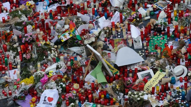 Flowers, messages and candles form a memorial tribute to the victims of terrorists.
