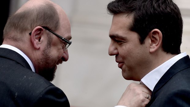 Greek Prime Minister Alexis Tsipras gets his collar waggled by European Parliament Chairman Martin Schulz before their meeting in Athens.