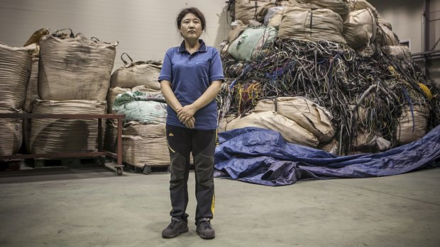 Kim Ryen-hi, who left North Korea four years ago, at a recycling plant where she operates a machine that chops up wires in Yeongcheon, South Korea.