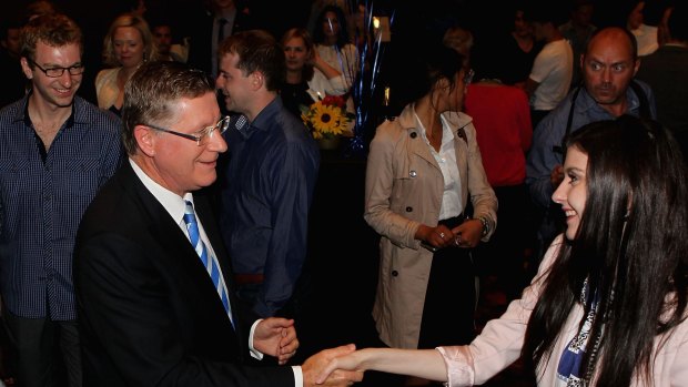 Dr Napthine meets supporters after his concession speech with son Tom following.