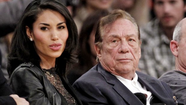 Donald Sterling and V. Stiviano watch the Los Angeles Clippers play the Los Angeles Lakers, in a file picture