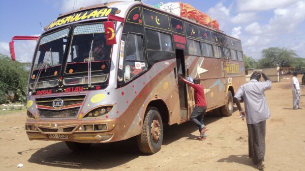 Earlier attack ... Rescue workers walk near a Nairobi-bound bus that was ambushed outside Mandera town on November 22. 28 non-Muslims were executed.
