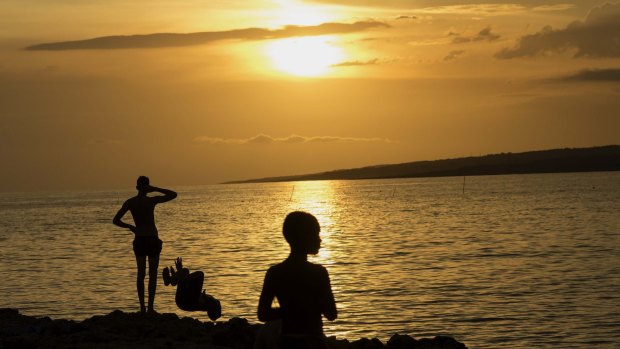 Hot times: People watching a sunset at La Boca beach in Sancti Spiritus, Cuba.