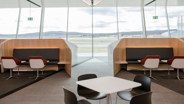 Floor-to-ceiling windows provide natural light and a clear view of the runways.
