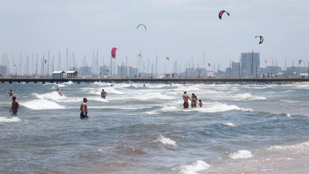 Swimmers enjoy the sun and surf at St Kilda beach where there was a shark alert on Sunday.