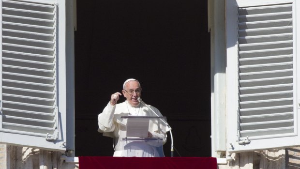 Pope Francis delivers the Angelus noon prayer from his studio window overlooking St Peter's Square at the Vatican on  when he condemned the attack by extremists in Mali.