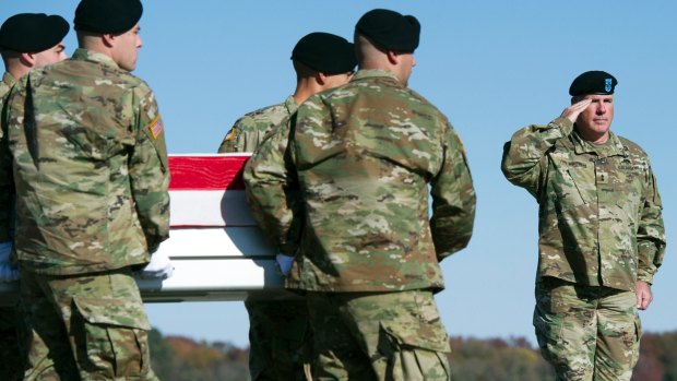 An Army carry team moves a transfer case containing the remains of Army Specialist Ronald Murray, of Bowie, Maryland. 