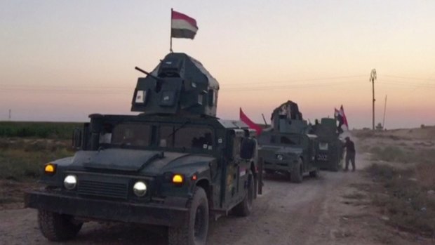 Iraqi soldiers on military vehicles in the Qatash area towards Kirkuk gas plant, south of Kirkuk, Iraq.